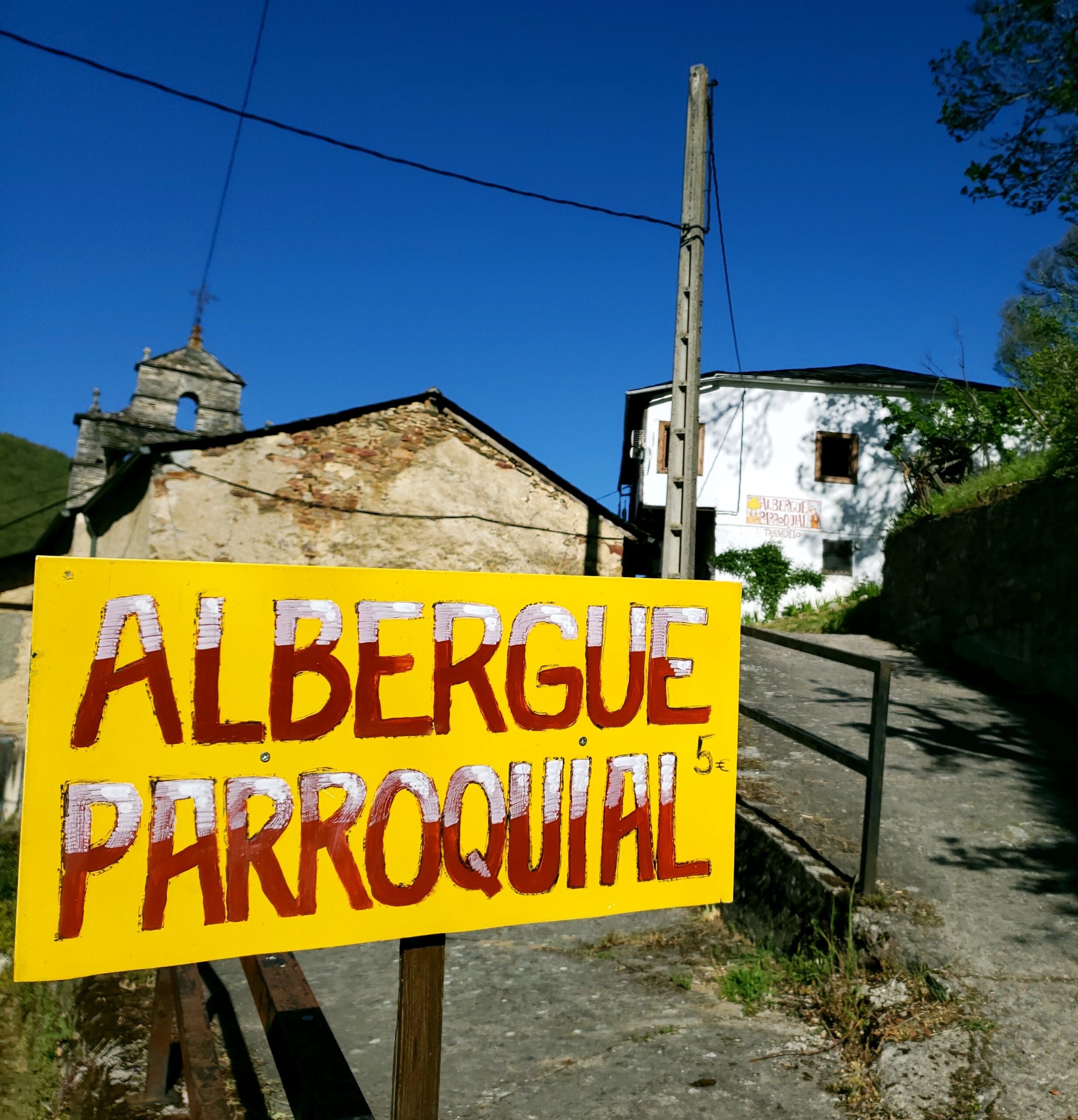 A hospitalero welcoming pilgrims at an albergue