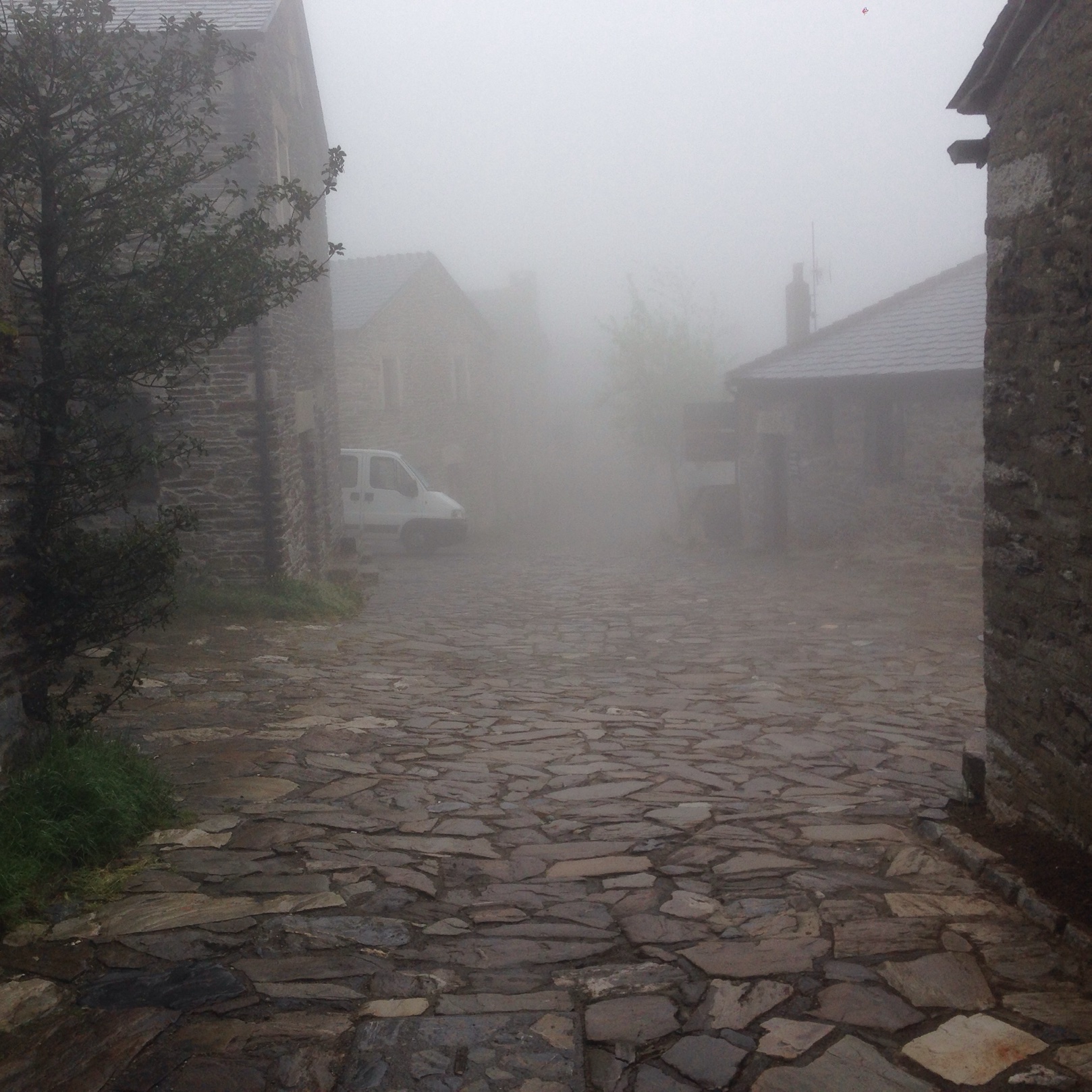 O Cebreiro in the fog, stone houses along a cobbled street